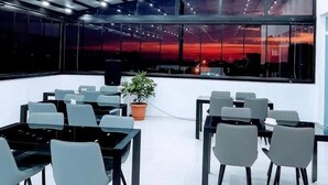 A modern conference room with glass walls, a large table, and chairs. - Hotel Mimino & Restaurant (Batumi)