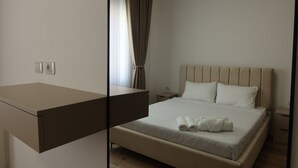 Ein Hotelzimmer mit Bett, Nachttisch und Spiegel.