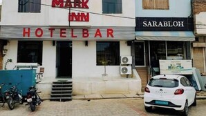 A hotel with a sign reading 'Mark Inn Hotel Bar' and 'Sarabloh' on adjacent buildings. - HOTEL MARK INN (Hanumangarh)