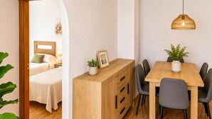Una habitación de hotel con cama, mesita de noche y vistas a través de un arco.
