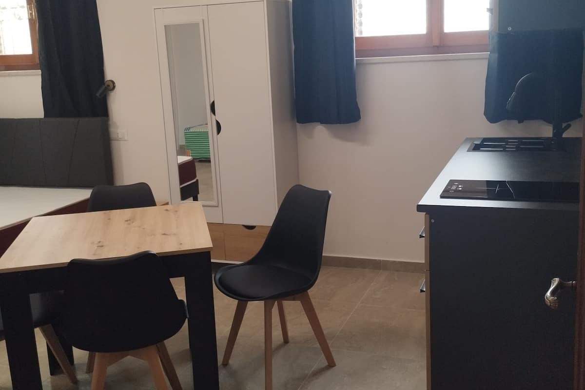 Basic Studio, Sea View | Living area | 32-inch flat-screen TV with cable channels