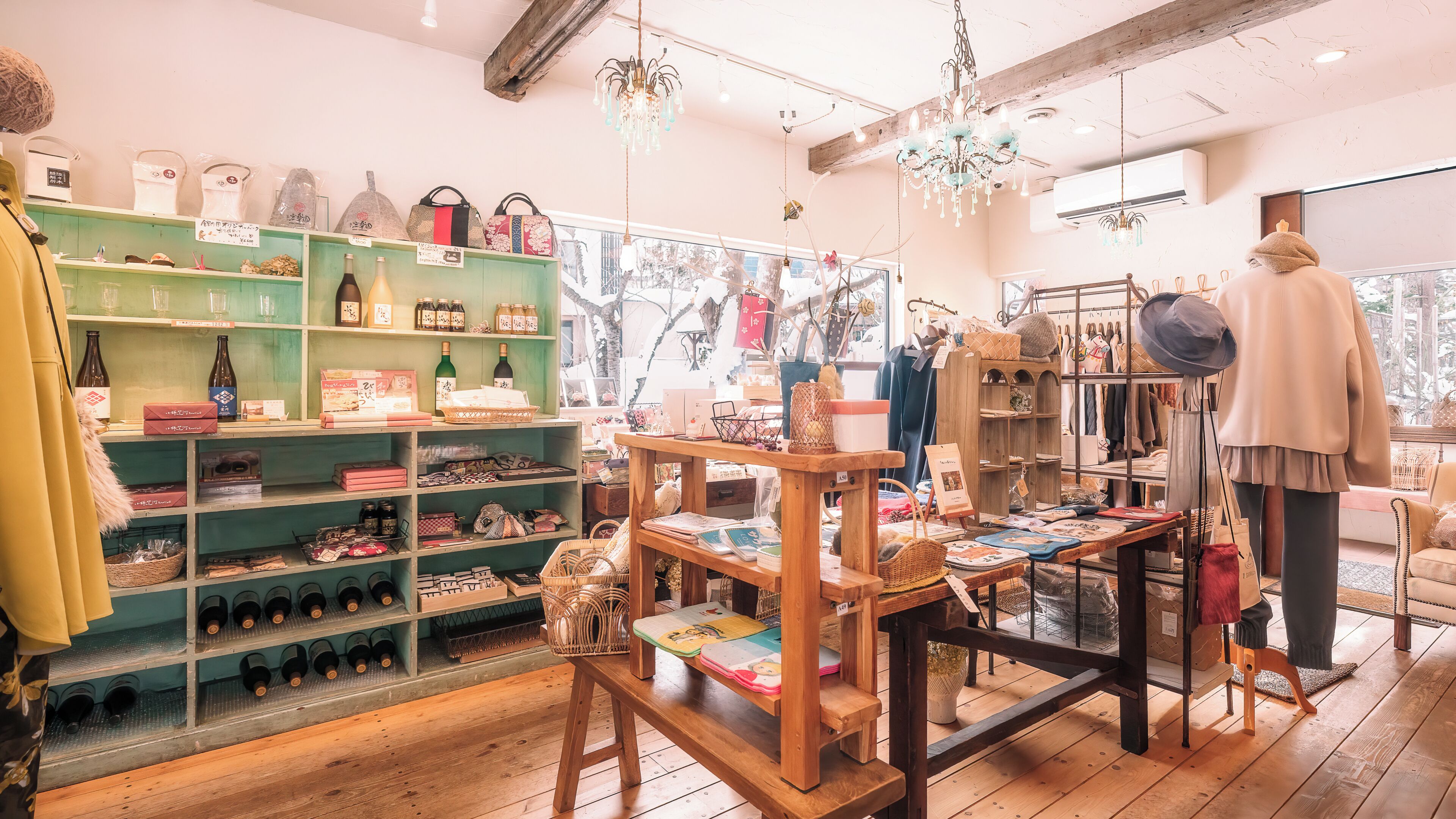 A boutique store with shelves of bottles, a mannequin, and a wooden table with items.