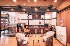 A traditional Japanese interior with tatami flooring, wooden furniture, and a central dining area. - Otaru Kourakuen (Otaru)
