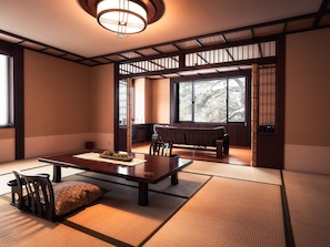 A traditional Japanese room with tatami flooring, a low table with a placemat, a cushion, a bench, and a sliding door leading to another room. - Otaru Kourakuen (Otaru)