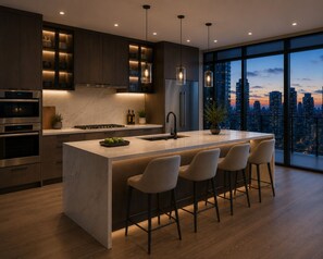 A modern kitchen with a large island, bar stools, and a city view. - The Robertson by Bukit Bintang (Kuala Lumpur)