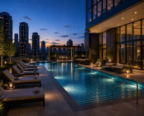 A rooftop pool with lounge chairs and a bar area, surrounded by high-rise buildings. - The Robertson by Bukit Bintang (Kuala Lumpur)