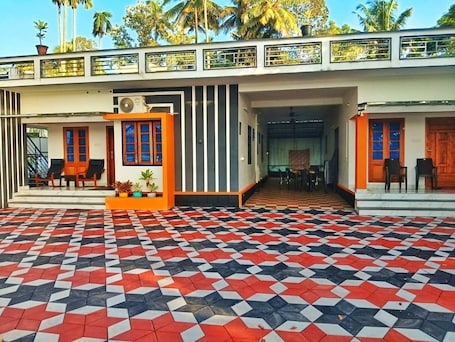 A building with a checkered floor, a covered entrance, and a staircase leading to a door.. LAKE OF ALSIMA