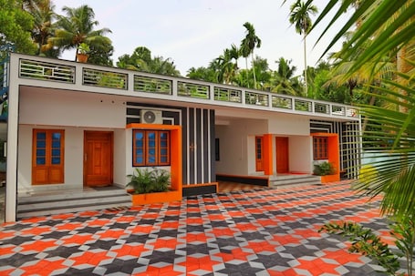 A building with a geometric patterned floor, multiple doors, and a balcony with railings.. LAKE OF ALSIMA