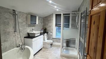 Separate bathtub and shower, deep-soaking bathtub, towels