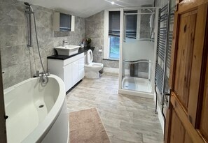 Separate bathtub and shower, deep-soaking bathtub, towels