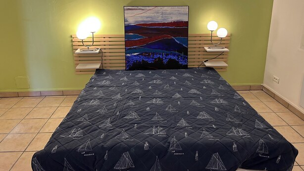 A bedroom with a bed, two bedside lamps, a wall-mounted light, and a painting. - Country House 2 apartments 15 kms from Vaison le Romaine facing Mont Ventoux, (Travaillan)