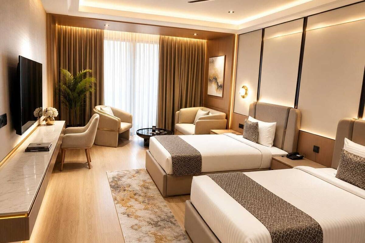 A modern hotel room with two beds, a desk, a chair, a TV, and a large window with curtains.