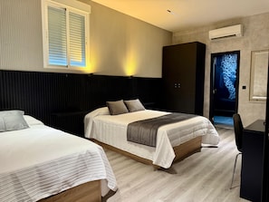 A hotel room with two beds, a wardrobe, a desk, and a television. - Hotel Reset (Humanes de Madrid)