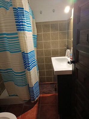 A bathroom with a shower curtain, a sink, and a door. - Country cottage. Totally isolated. Near Petrola salt lakes (Pétrola)