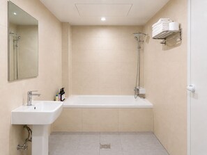 A bathroom with a sink, mirror, shower, and towel rack. - Yoonstay Haenggung (Suwon-si)