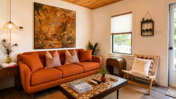 A living room with a sofa, coffee table, and a chair.
