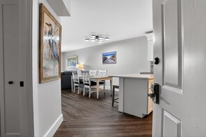 A modern kitchen with a dining area, wooden flooring, and a ceiling light fixture. - 2 Bedroom 2 Bathroom Condo - Completely Renovated Short Walk to the Beach (Hilton Head Island)