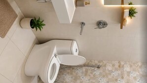 A modern bathroom with a toilet, a sink, a shower, and a patterned floor. - Casa Bella  (Sohna)