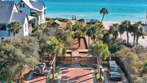 A coastal property with a paved driveway, a vehicle, and a beach view. - Heron Walk, 30A Condo, Pool, Beach (Santa Rosa Beach)