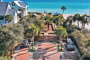 A coastal property with a paved driveway, a vehicle, and a beach view. - "Heron Walk" Blue Mountain Beach, 30A Condo, Pool, Beach Access (Santa Rosa Beach)
