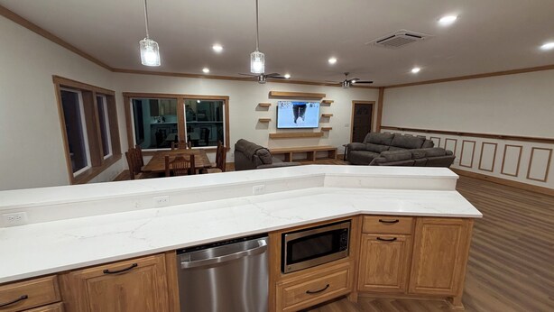 A modern kitchen with a dishwasher, microwave, and wooden cabinets. - Mountain Top Sunsets on 12 secluded acres!  Brand new house finished in 2026 (Mena)