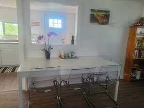 A modern kitchen with a white countertop, a sink, and a window.