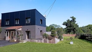 A modern two-story house with a flat roof, a front porch, and a well-maintained lawn. - Quiet house in the middle of fields 15 min from Bayeux, 30 from the landing beaches (Aurseulles)
