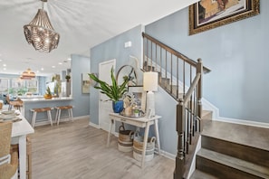 Un interior moderno con una escalera, un comedor y una cocina.