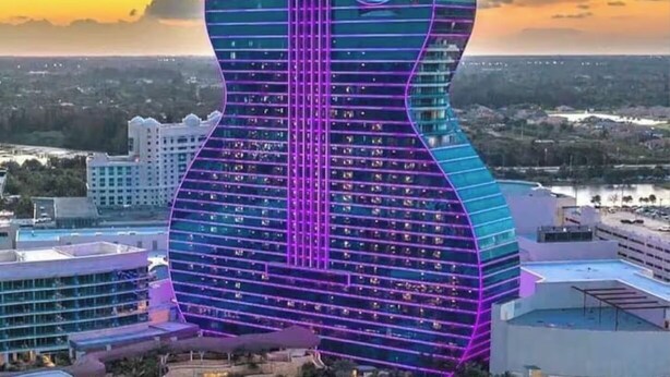 A hotel with a guitar-shaped building, a pool area, and surrounding resort buildings. - 1 bedroom Private Studio with Patio. 5 Min to Hard Rock Stadium & Every Event. (Miami Gardens)