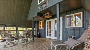 A covered outdoor area with wooden flooring, seating arrangements, and a sign indicating a cinema.