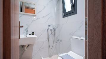 Economy Apartment, Garden View | Bathroom | Shower, towels, soap, shampoo