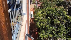 A balcony with a view of the sea, a tiled patio, and a garden area with various plants. - Dalhia's House: stunning gulf and mountain views, Wi-Fi, A/C Free parking (Cala Gonone)