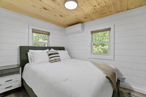 A bedroom with a bed, two windows, a nightstand, and a dresser. - Robin`s Rest, Saylors Lake w/ Pond & Fire Pit (Saylorsburg)