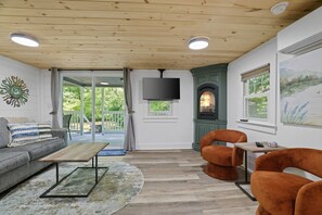 A living room with a sofa, a coffee table, a fireplace, and a television. - Robin`s Rest, Saylors Lake w/ Pond & Fire Pit (Saylorsburg)