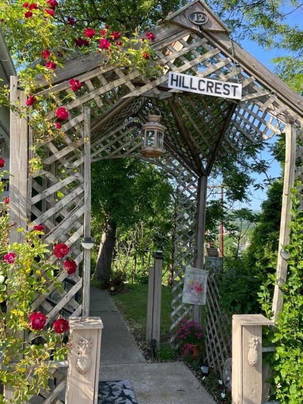 A wooden archway with a sign reading 'HILLCREST' and a lantern hanging from it.