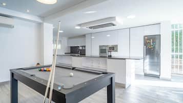 Een moderne keuken met een ingebouwde magnetron, kookplaat en koelkast.