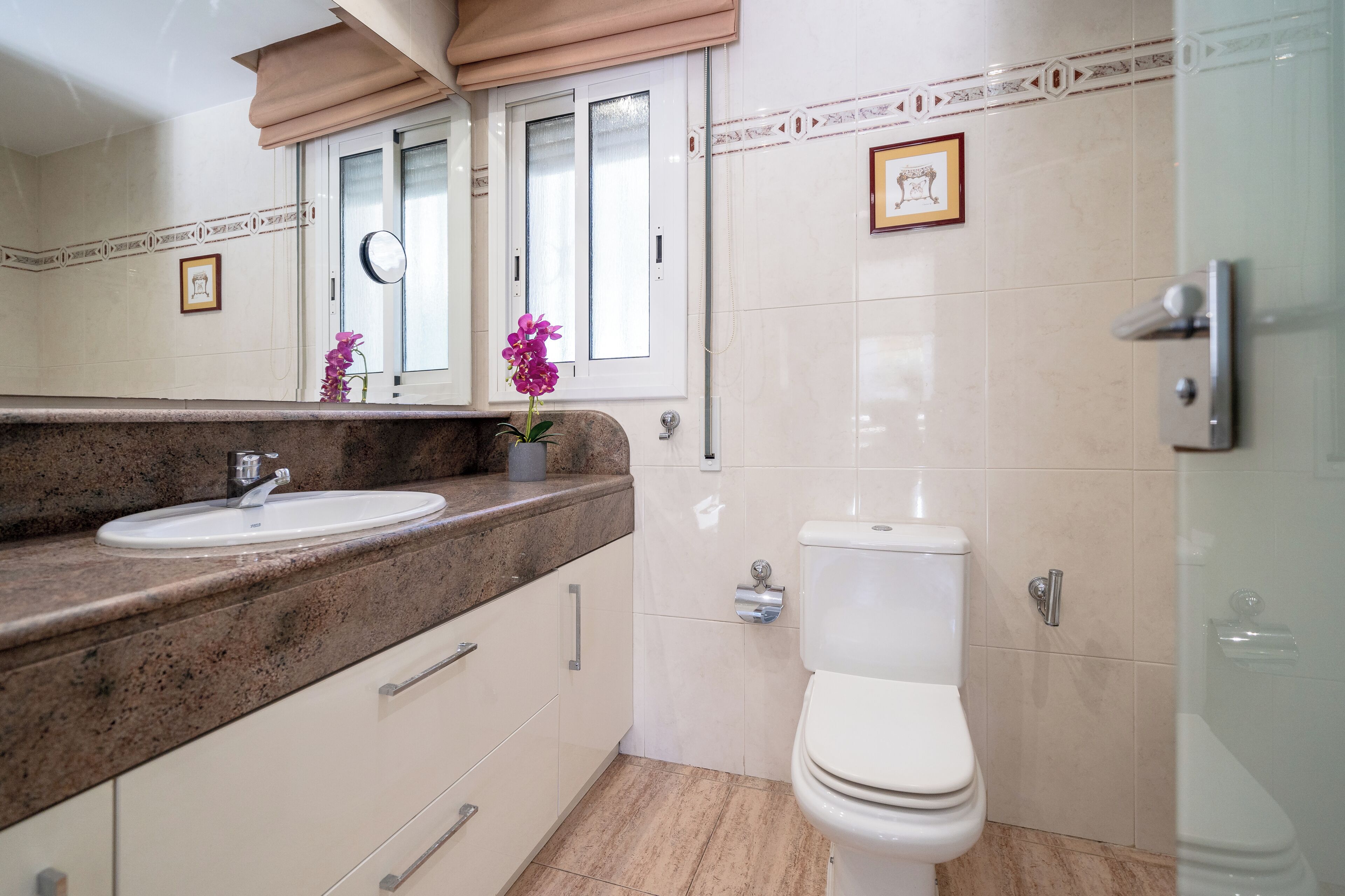 A bathroom with a sink, toilet, and shower.