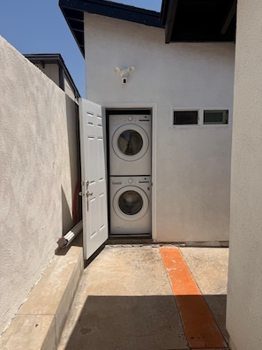 Convenient private outdoor laundry with stacked washer and dryer