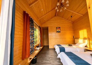 A wooden cabin with two beds, a bench, a painting, and a ceiling light fixture. - Semporna Fairy Waterfront Resort (Semporna)