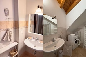 Ein Badezimmer mit Waschbecken, Spiegel, Handtuchhalter und einer Waschmaschine.