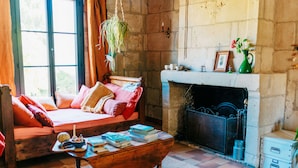A cozy room with a bed, a fireplace, and a bookshelf. - Peace, nature and old stones (Berthenay)