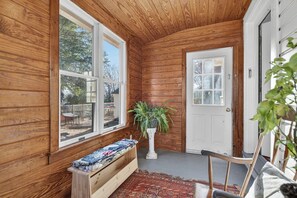 A wooden interior with a bench, a potted plant, and a door. - Charming Virginia Horse Country Retreat (Marshall)