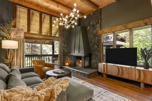 A cozy living room with a fireplace, comfortable seating, and a television.