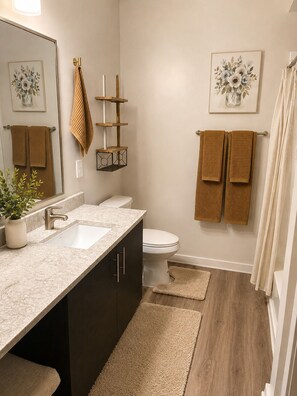 A bathroom with a sink, toilet, and a towel rack. - Luxury 2BR Retreat Near FIFA World Cup & Mercedes-Benz Stadium (Atlanta)
