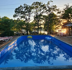 A swimming pool with a clear view of trees and a gazebo in the background. - LAKE NORFORK cottages at a FANTASTIC FISHING resort,1-2bedrooms,electric trolley (Gamaliel)