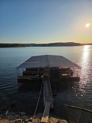 A dock extending into calm water with a clear sky. - LAKE NORFORK cottages at a FANTASTIC FISHING resort,1-2bedrooms,electric trolley (Gamaliel)
