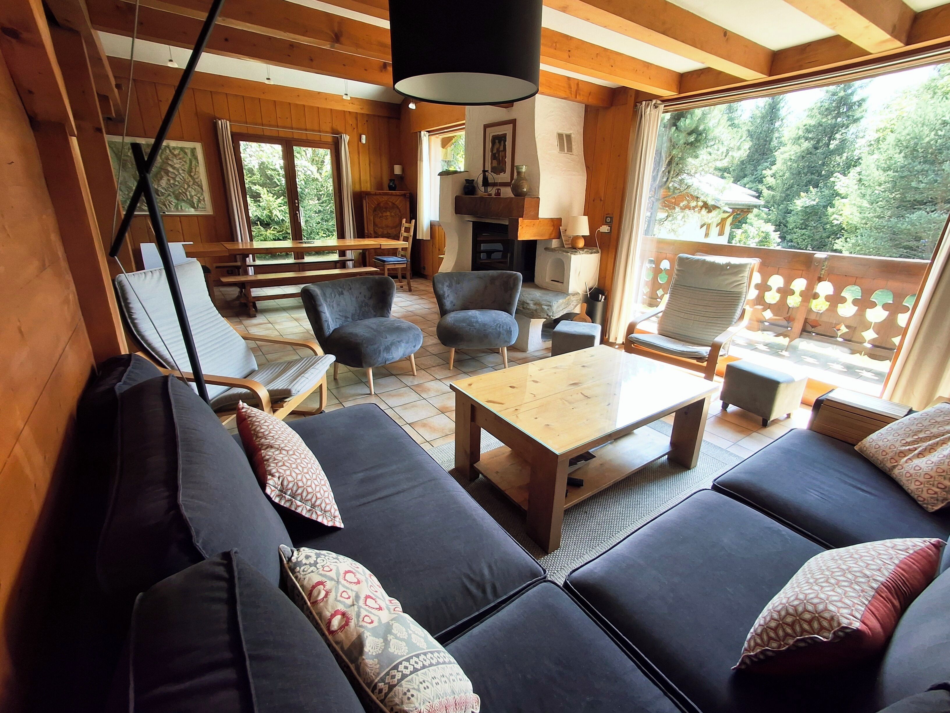 A cozy living area with a sofa set, a coffee table, and a fireplace.