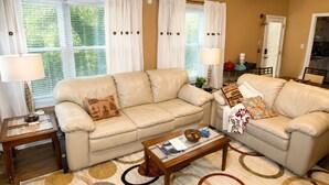 A living room with two beige sofas, a coffee table, and a patterned rug. -  FIFA World Cup Atlanta Stay Sleeps 4 Pool 11 Min to Mercedes-Benz Stadium (Atlanta)