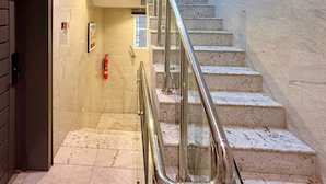 A marble staircase with metal railings leading to an upper floor. - Citiscape Apartment (Ikeja)