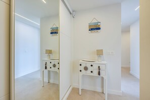 A modern bathroom with a white vanity, a mirror, and decorative wall signs. - LXR Nice 3-Bedroom Oceanfront (Fuengirola)